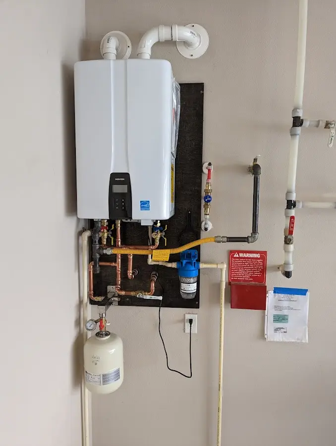 Professional plumber installing copper piping in a Boaz home